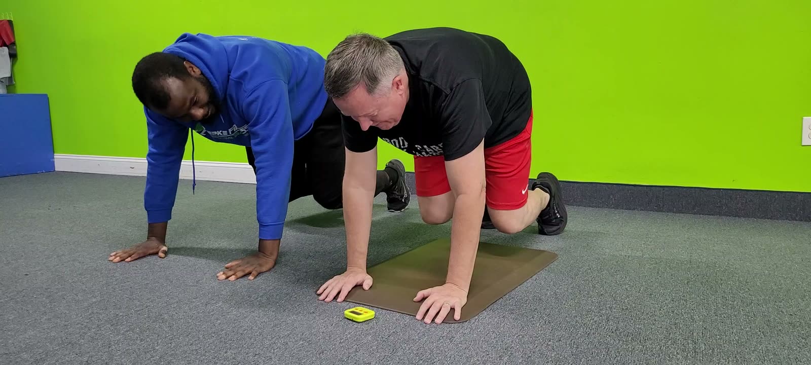 Personal trainer coaching a client through a floor exercise in Millersville, MD