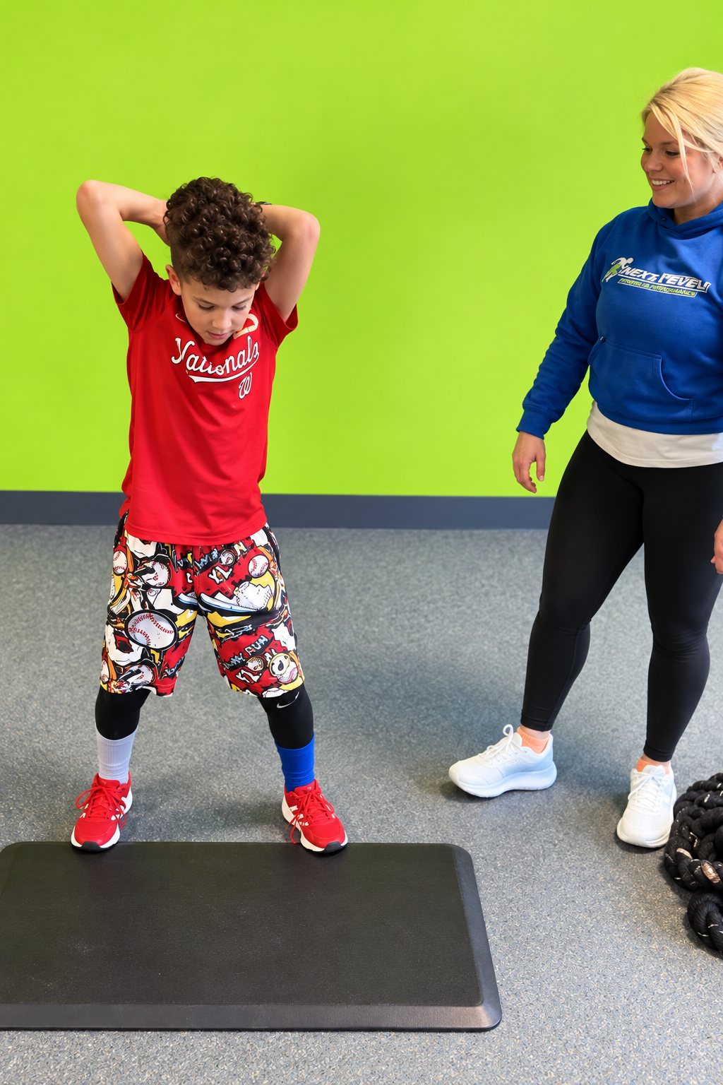 Repke Fitness trainer coaching a young client through a bodyweight exercise in Millersville, MD